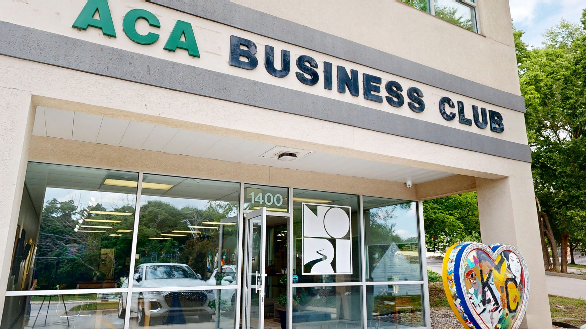 ACA Business Club entrance at 1400 NW Vivion Rd, Kansas City &mdash; storefront entrance with painted KC heart sculpture